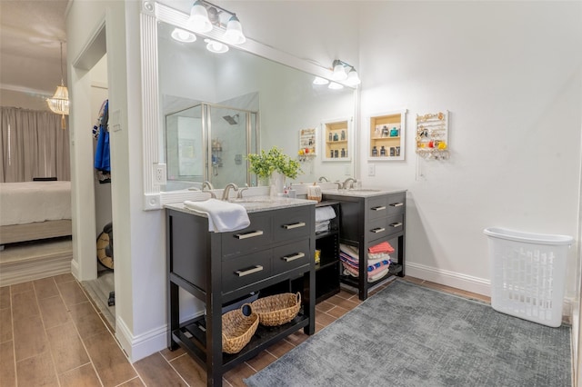 bathroom with hardwood / wood-style floors, vanity, and a shower with shower door