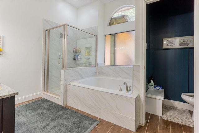 full bathroom featuring toilet, vanity, shower with separate bathtub, and hardwood / wood-style flooring