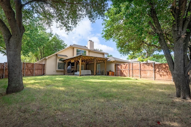 back of property featuring a yard