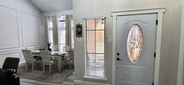 foyer with lofted ceiling and hardwood / wood-style flooring