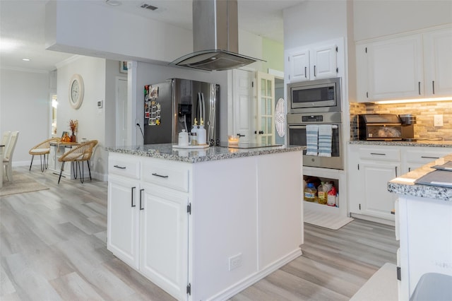 kitchen featuring a kitchen island, island exhaust hood, white cabinetry, and stainless steel appliances