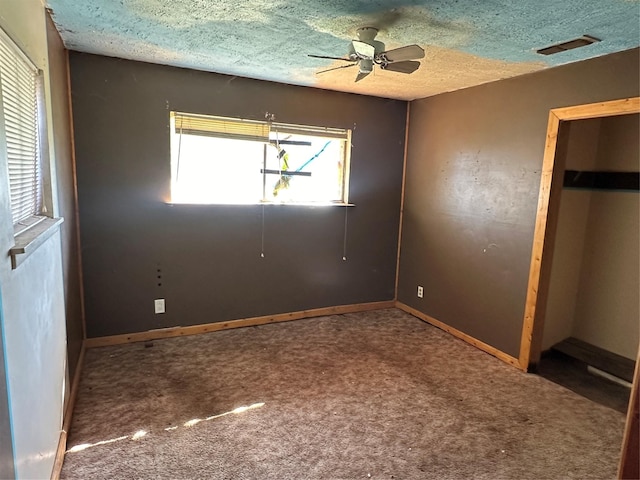 unfurnished bedroom with carpet flooring, ceiling fan, and a textured ceiling