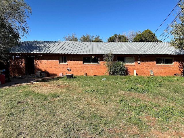 back of property featuring a yard