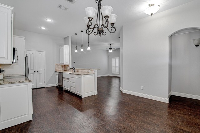 bedroom with a tray ceiling, ceiling fan, and dark hardwood / wood-style floors