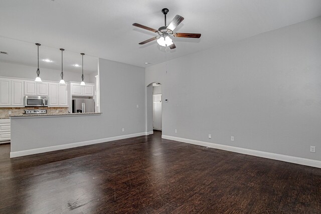 bedroom with ensuite bath, a raised ceiling, ceiling fan, sink, and wood-type flooring