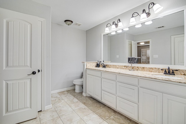 bathroom with tile patterned floors, vanity, and toilet