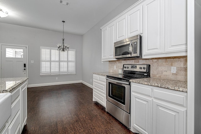 kitchen featuring decorative light fixtures, white cabinets, dark hardwood / wood-style flooring, backsplash, and stainless steel appliances