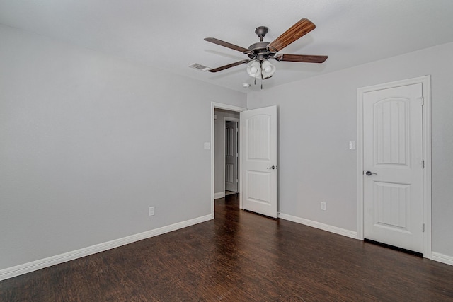 unfurnished bedroom featuring ceiling fan and dark hardwood / wood-style flooring