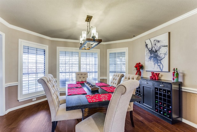 dining area featuring dark hardwood / wood-style flooring, a wealth of natural light, and an inviting chandelier