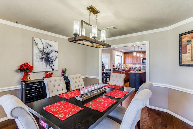 dining space featuring crown molding, a chandelier, and dark hardwood / wood-style floors