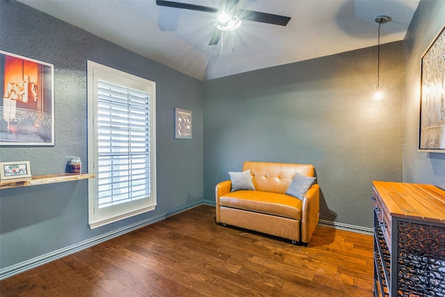 sitting room with ceiling fan, dark hardwood / wood-style flooring, and lofted ceiling