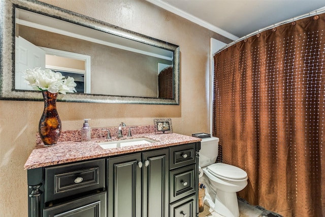 bathroom with vanity, toilet, and crown molding