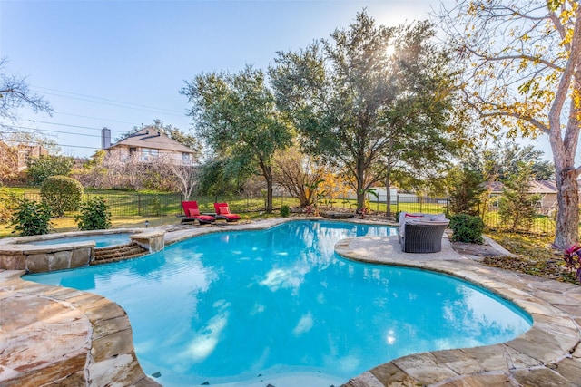 view of swimming pool with an in ground hot tub and a patio area