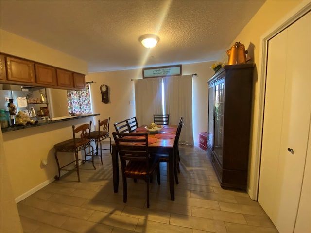 dining space featuring a textured ceiling