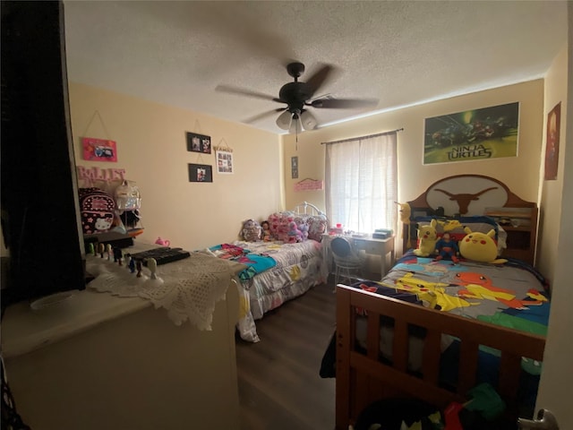 bedroom with a textured ceiling, dark hardwood / wood-style floors, and ceiling fan