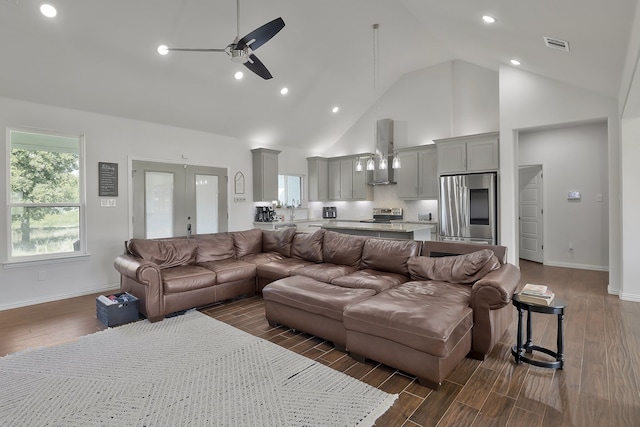 living room featuring dark hardwood / wood-style floors, ceiling fan, high vaulted ceiling, and french doors