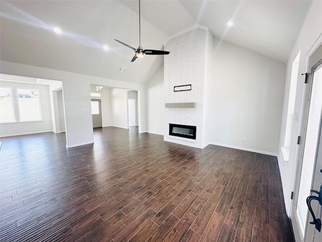 unfurnished living room featuring a fireplace, high vaulted ceiling, dark hardwood / wood-style floors, and ceiling fan