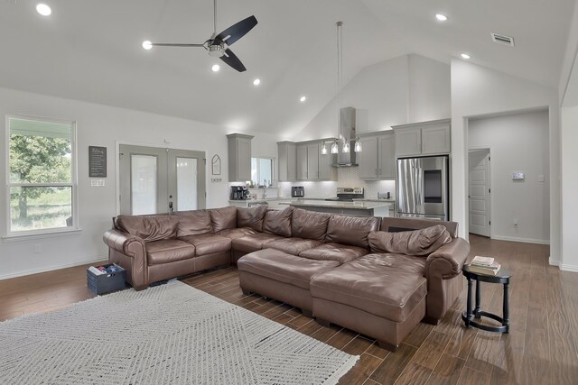 kitchen with vaulted ceiling, a center island, stainless steel appliances, and plenty of natural light