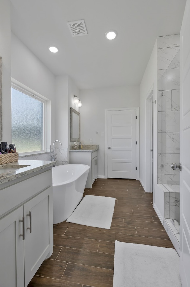 bathroom featuring vanity and a bathing tub