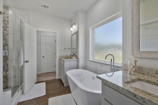 bathroom with vanity and separate shower and tub