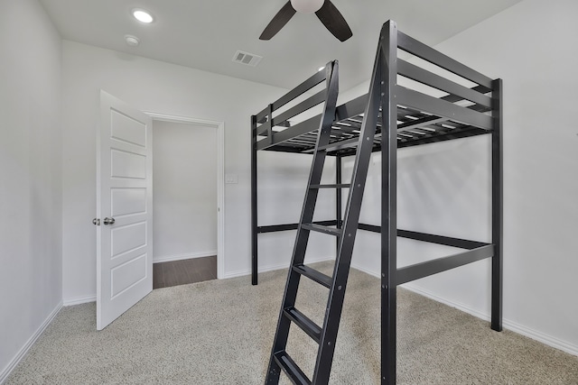 unfurnished bedroom featuring ceiling fan and carpet