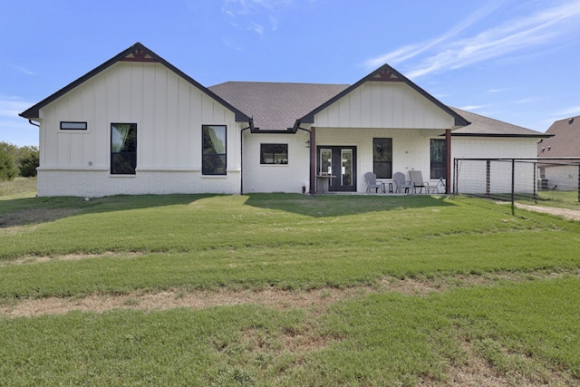 modern farmhouse featuring covered porch and a front lawn