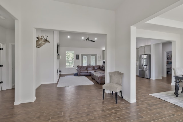 living room with ceiling fan, dark hardwood / wood-style flooring, and french doors