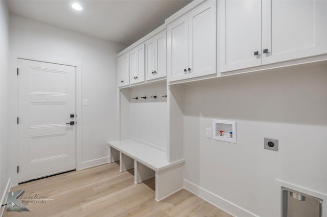 laundry room with cabinets, hookup for a washing machine, light hardwood / wood-style flooring, and electric dryer hookup