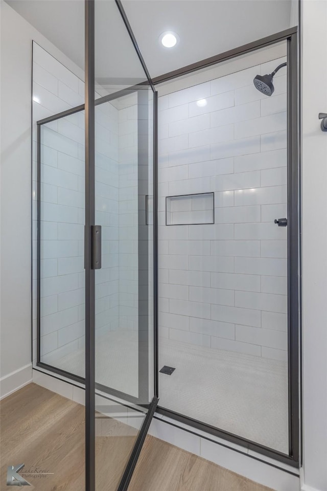 bathroom with hardwood / wood-style floors and walk in shower