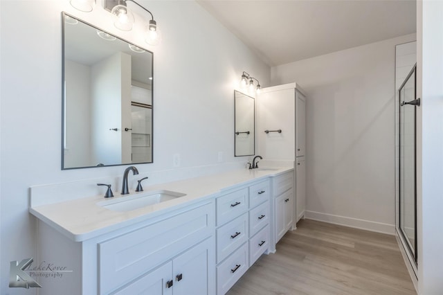 bathroom with vanity, hardwood / wood-style floors, and walk in shower