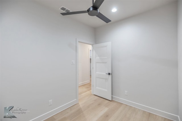 empty room with ceiling fan and light wood-type flooring