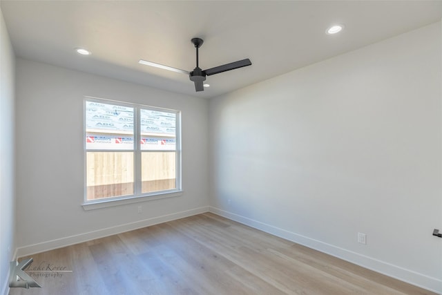 spare room with ceiling fan and light wood-type flooring