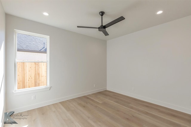 spare room with ceiling fan and light wood-type flooring