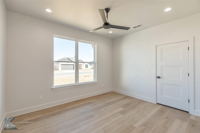 spare room featuring light hardwood / wood-style floors and ceiling fan