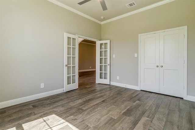 unfurnished bedroom featuring a closet, ceiling fan, french doors, and dark wood-type flooring