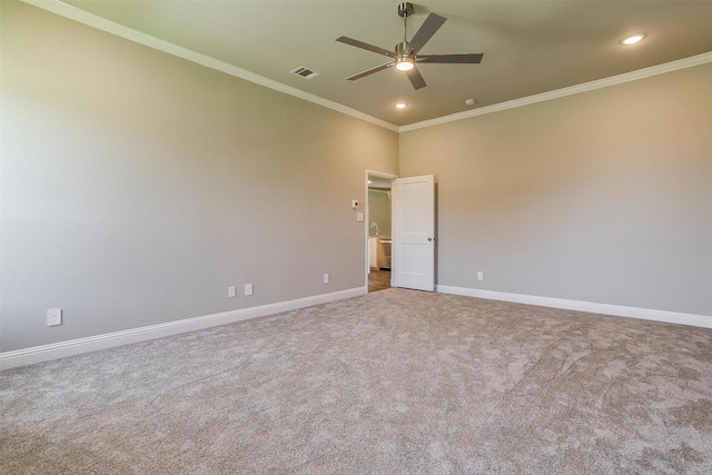 carpeted empty room with ceiling fan and crown molding