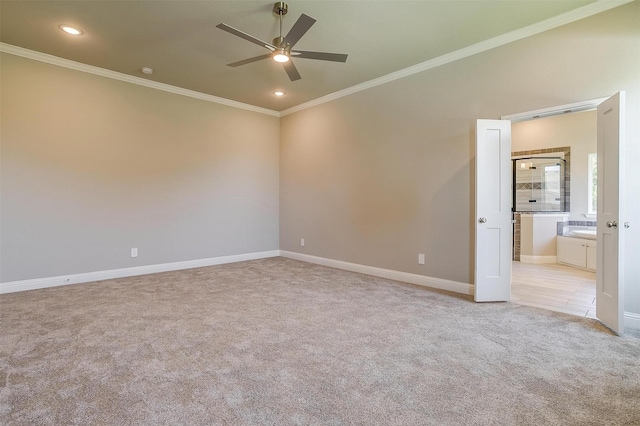 carpeted spare room featuring ceiling fan and ornamental molding