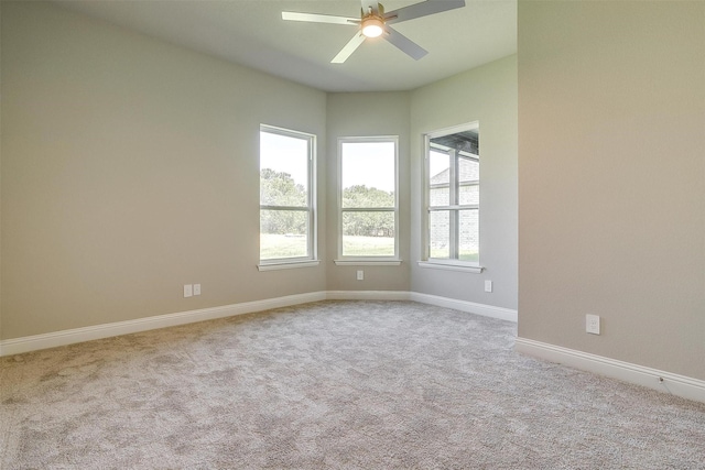 unfurnished room with ceiling fan, plenty of natural light, and light colored carpet