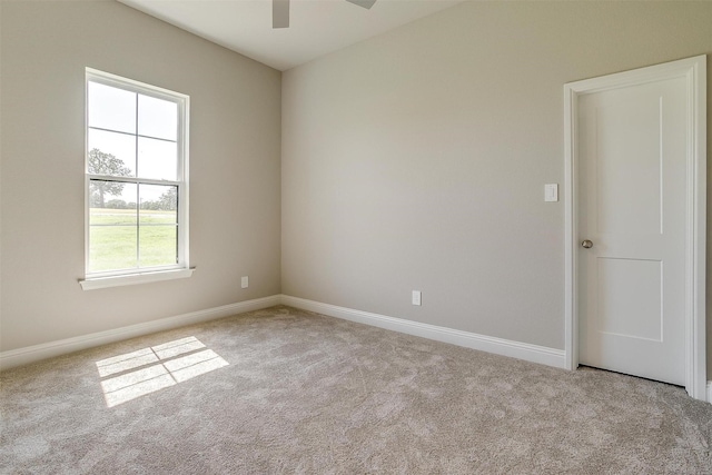 carpeted empty room featuring ceiling fan