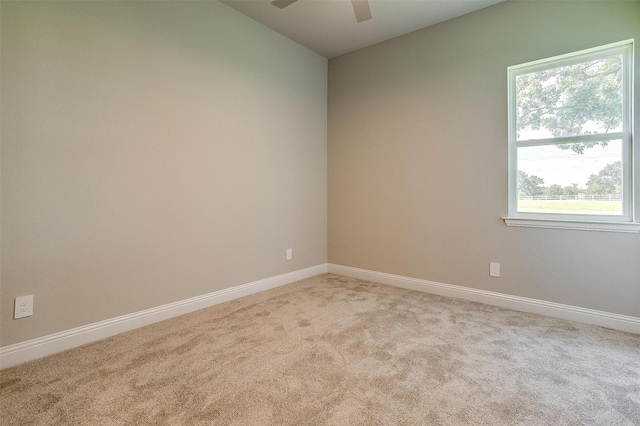 empty room featuring light carpet and ceiling fan