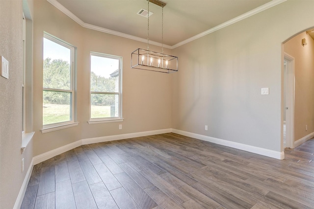 unfurnished dining area with crown molding, a notable chandelier, and hardwood / wood-style flooring