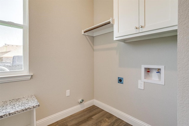 laundry area featuring cabinets, hookup for a washing machine, dark hardwood / wood-style flooring, and electric dryer hookup