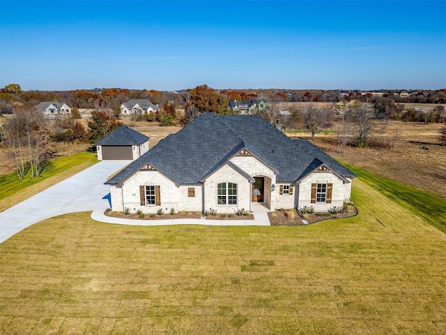 view of front of home with a front yard and a garage