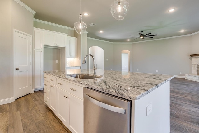 kitchen featuring white cabinetry, ceiling fan, sink, stainless steel dishwasher, and a center island with sink