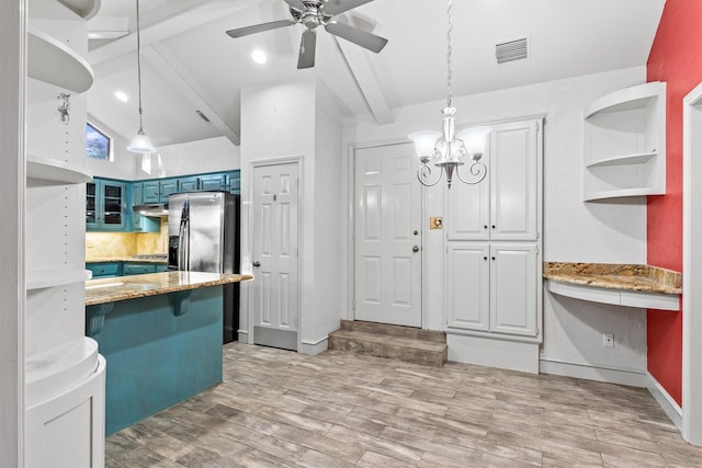 kitchen with a kitchen bar, blue cabinetry, pendant lighting, light hardwood / wood-style flooring, and vaulted ceiling with beams