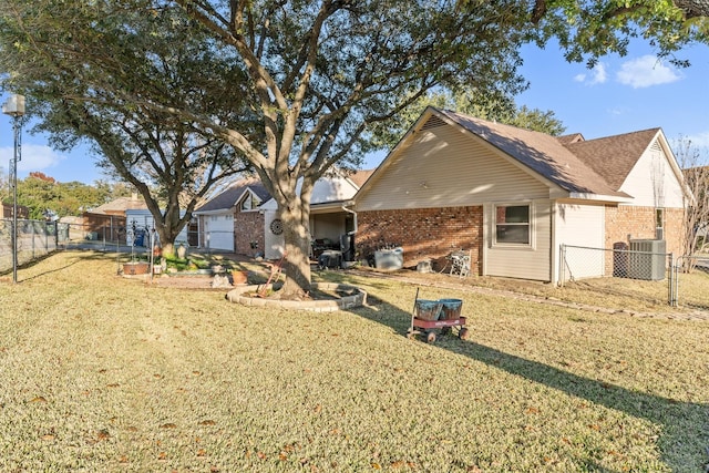 back of property featuring a lawn and central air condition unit