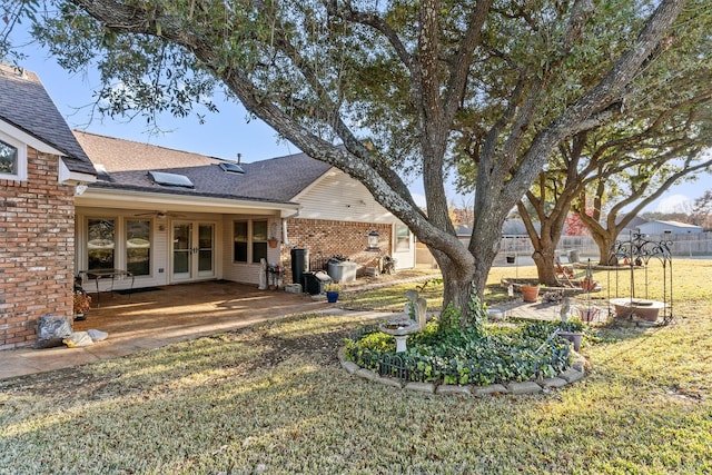 view of yard with french doors and a patio