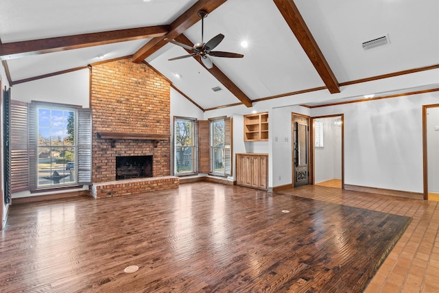 unfurnished living room with beam ceiling, high vaulted ceiling, hardwood / wood-style flooring, and a brick fireplace