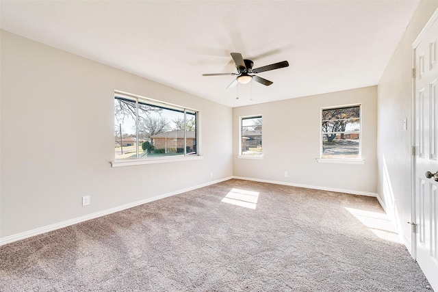 carpeted spare room featuring ceiling fan