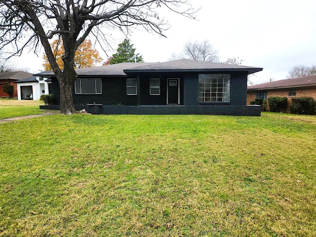 ranch-style home featuring central AC and a front yard